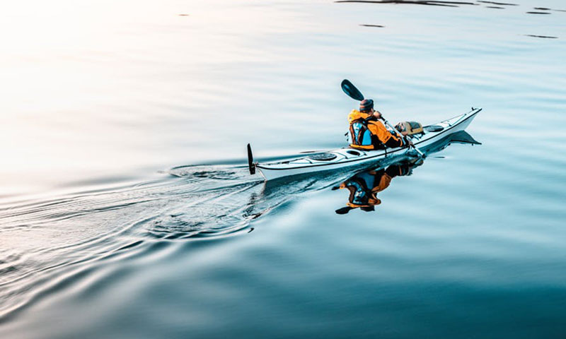 Man padeling a cano