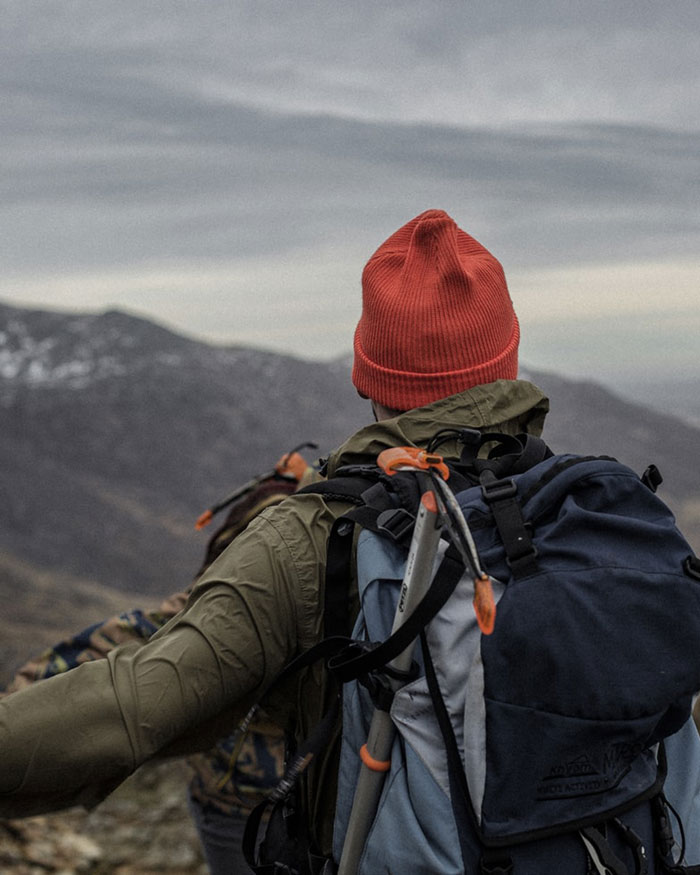 Man taking in the view on top of a mountain.